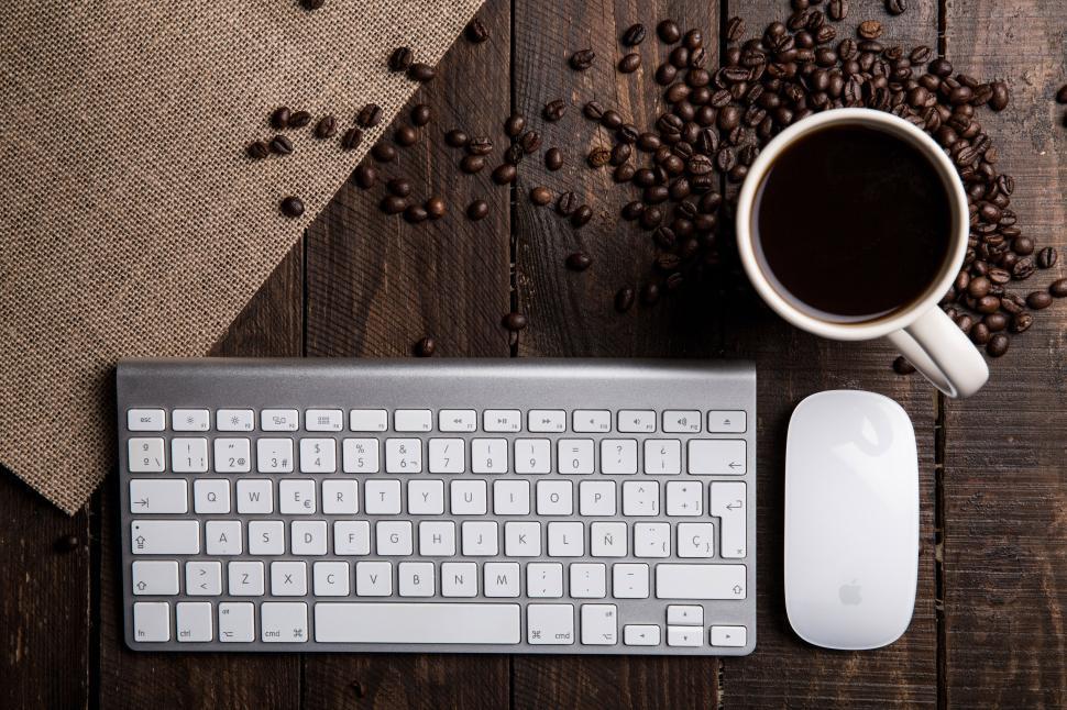 Free Image of Keyboard, mouse, coffee cup, and coffee beans. 