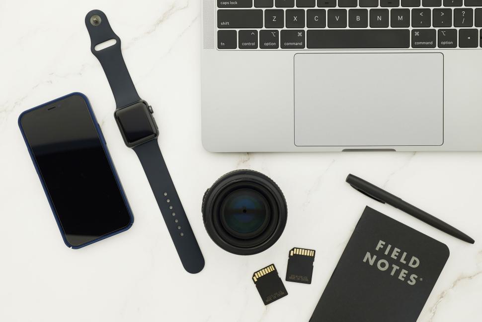 Free Image of Smartwatch, smartphone, laptop, and notebook on marble. 
