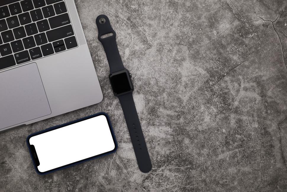 Free Image of Laptop with smartphone and smartwatch on gray surface 
