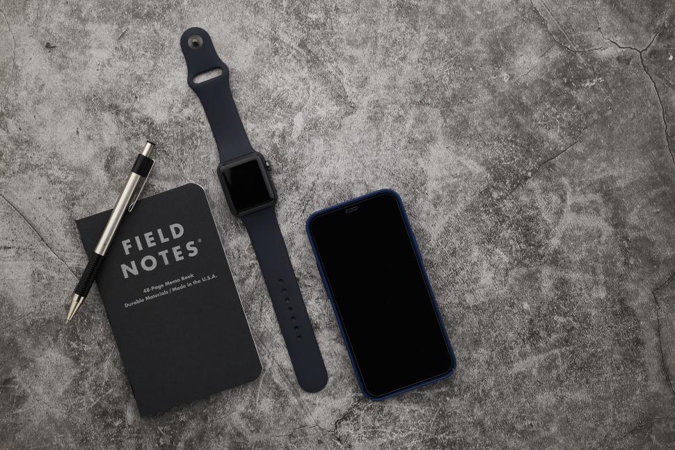 Free Image of Field notes, pen, smartwatch, smartphone on surface 