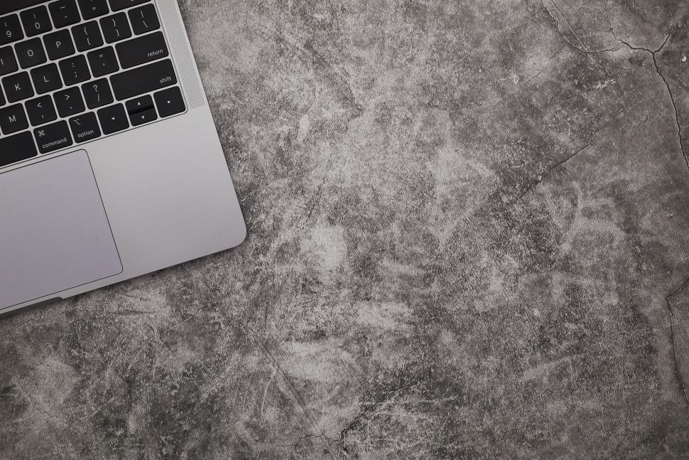 Free Image of Laptop on concrete surface creating a minimalistic feel 