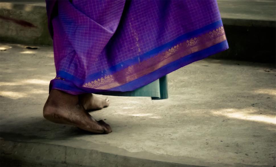 Free Image of Traditional attire with barefoot woman on rustic ground 