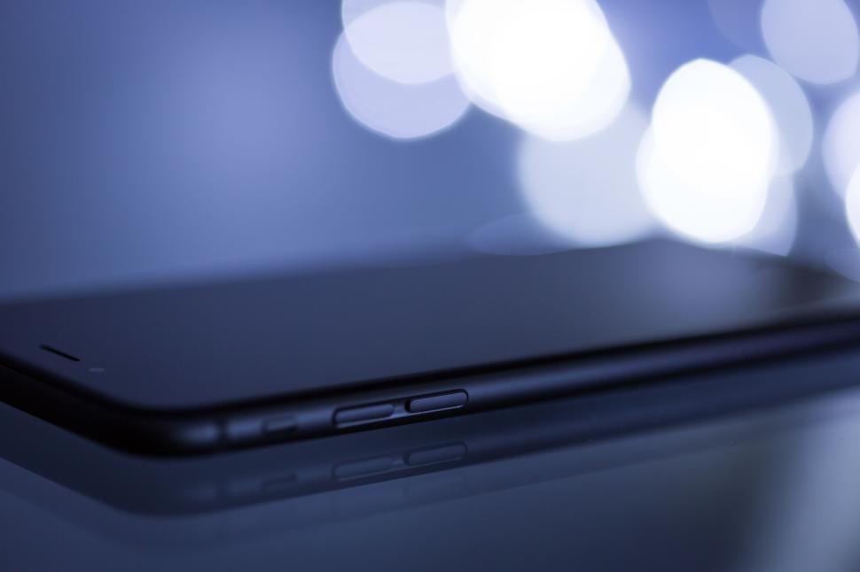 Free Image of Close-up of a modern smartphone with a reflective surface. 