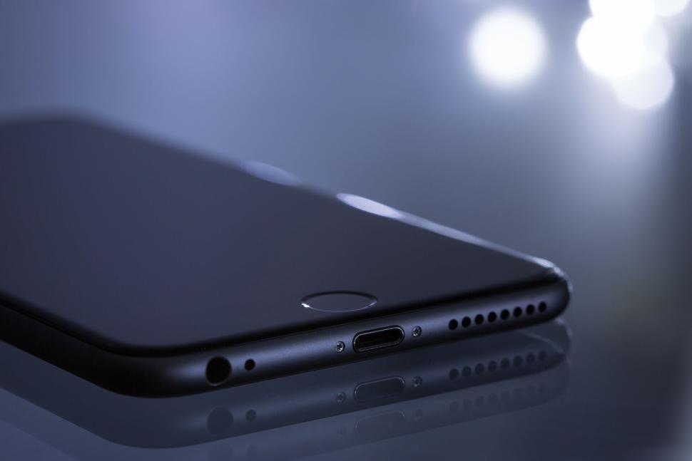 Free Image of Sleek dark smartphone highlighting side profile design. 