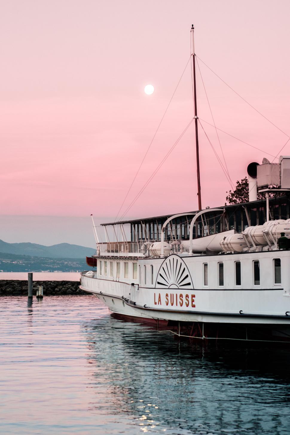 Free Image of La Suisse Boat Docked in Harbor During Romantic Sunset 