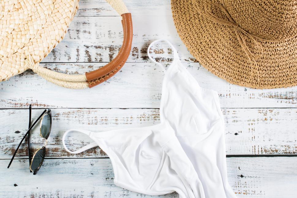 Free Image of Fashionable Summer Essentials with Straw Hat and Sunglasses 