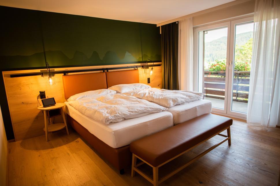 Free Image of Modern cozy hotel room with mountain view balcony. 