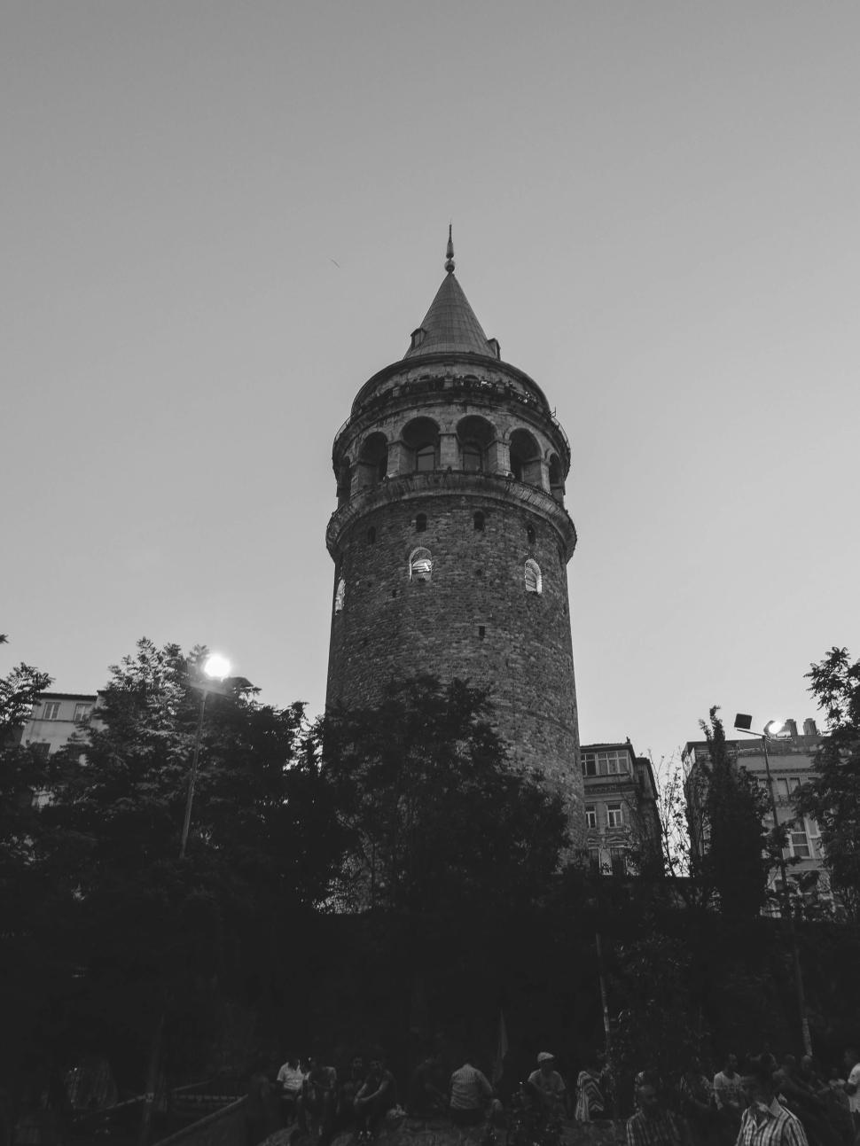 Free Image of Ancient stone tower among old city buildings evening 