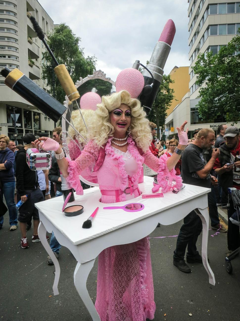 Free Image of Person in elaborate pink costume with makeup props outdoors 