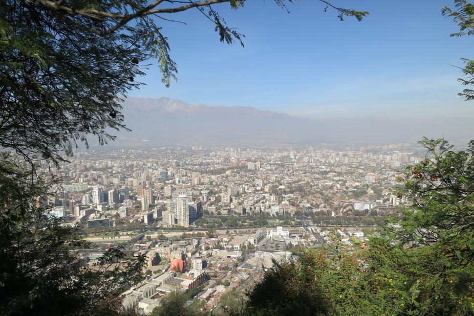 Free Image of Cityscape of urban area with buildings and mountains. 