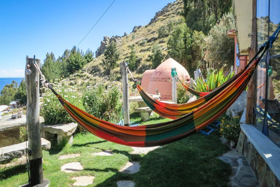 Free Image of Colorful hammocks strung up in a scenic outdoor setting 