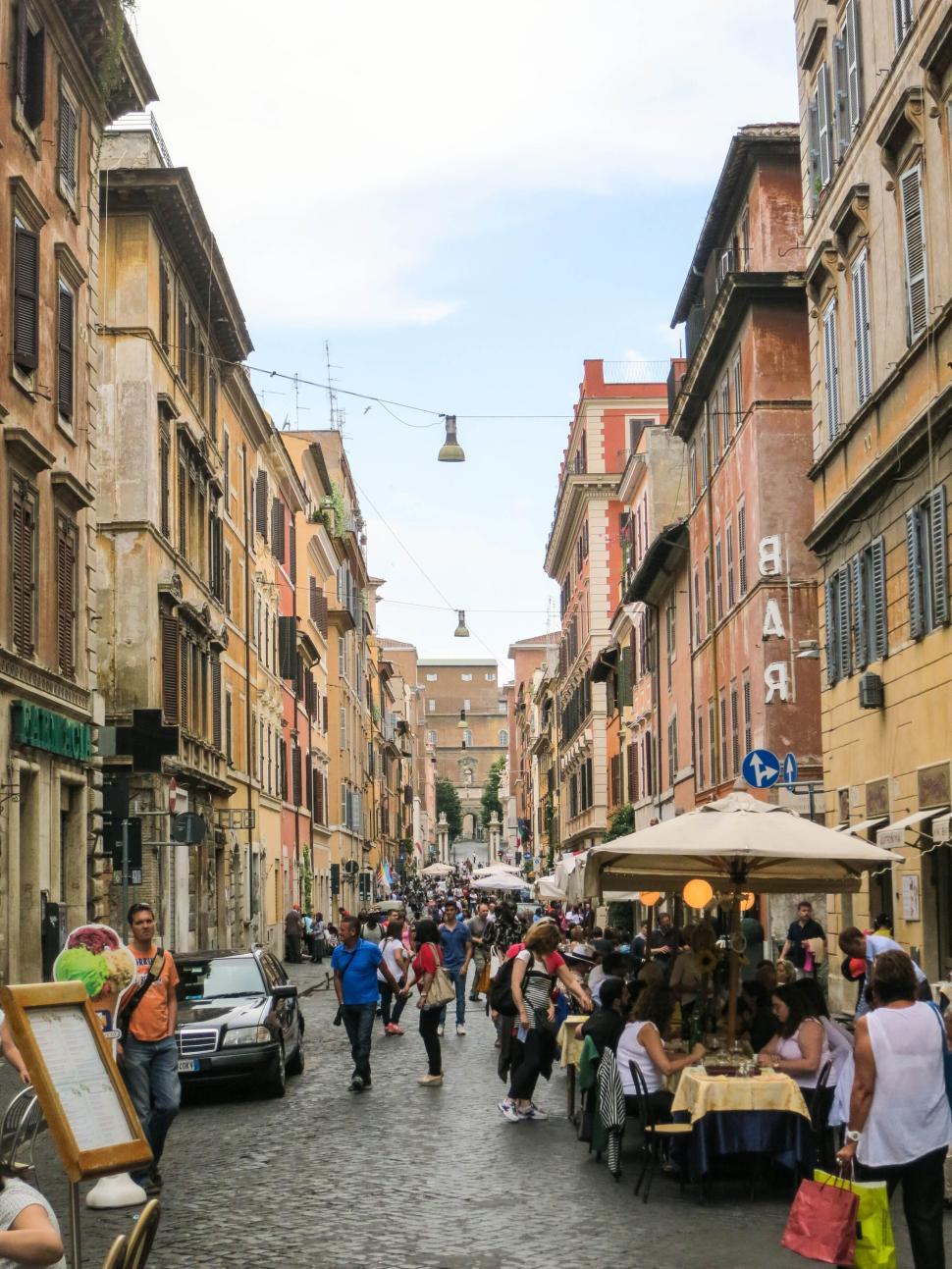 Free Image of Busy street with cafes and people in European city. 