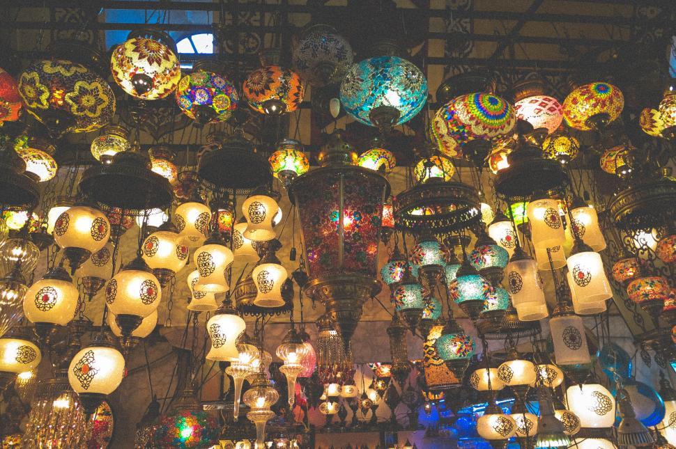 Free Image of Colorful mosaic lamps hanging in a vibrant market. 