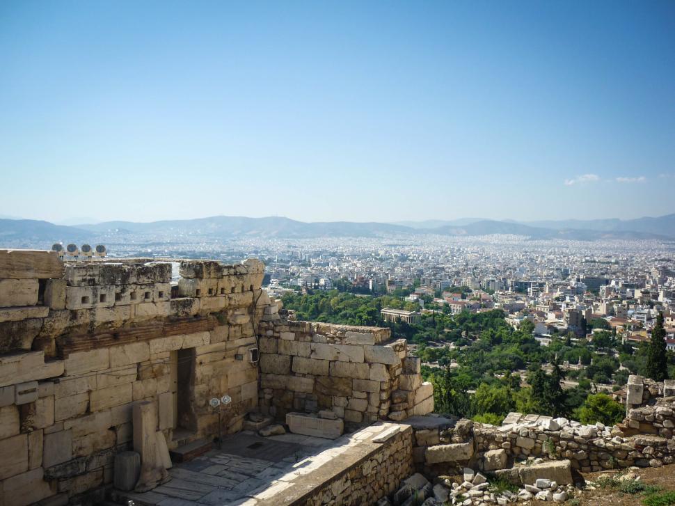 Free Image of Ancient ruins overlooking a modern city panorama. 