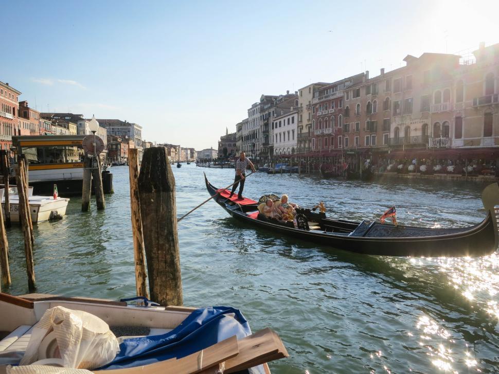 Free Image of Gondola ride in a charming urban canal under sunlight. 