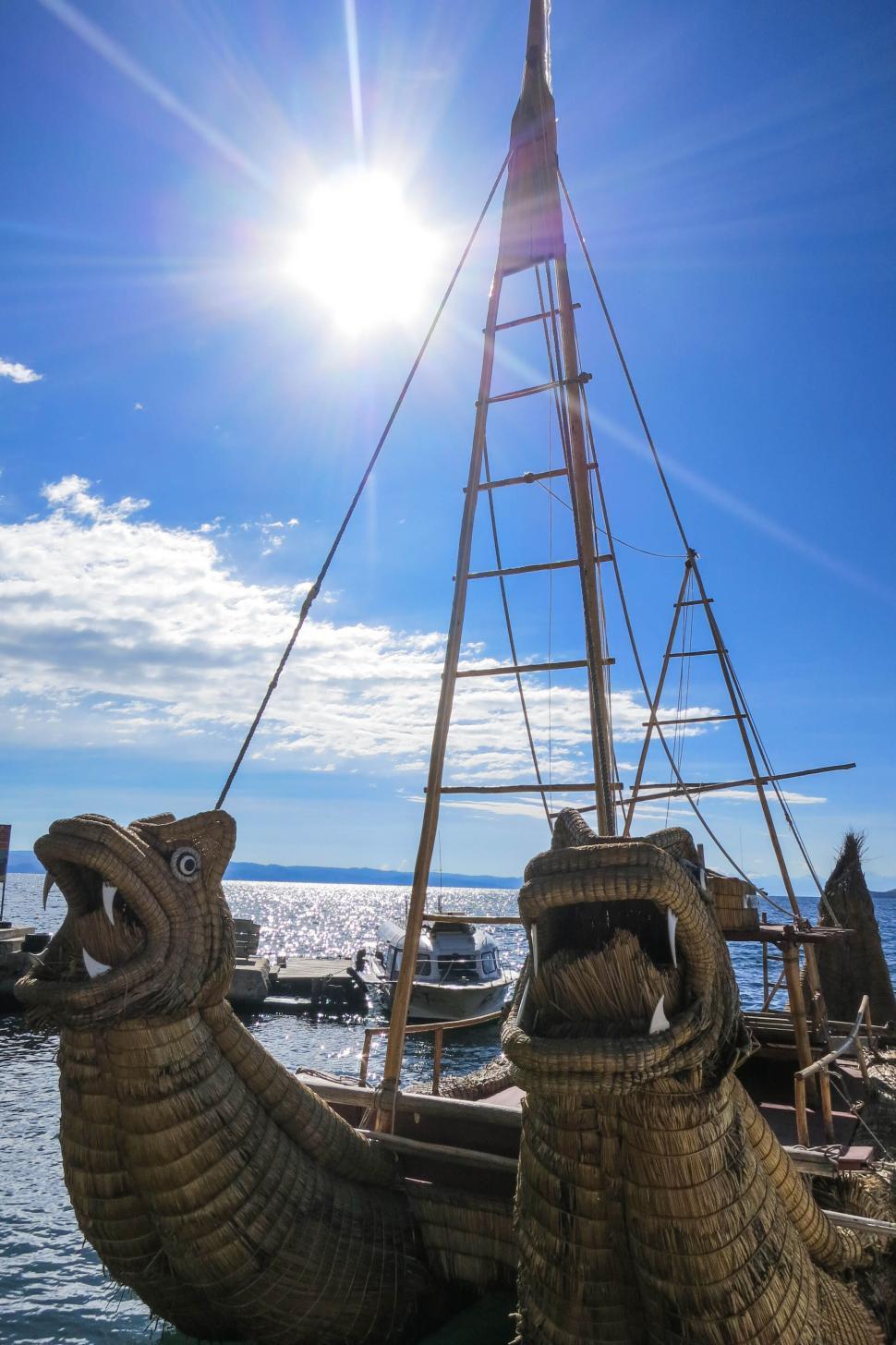Free Image of Traditional boat with dragon figureheads under bright sun. 