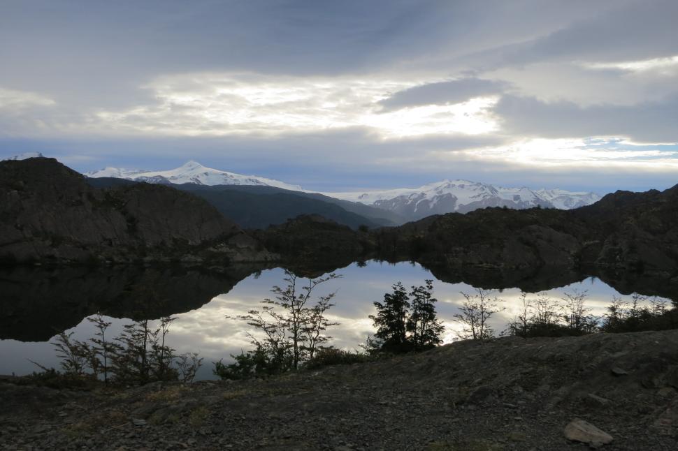 Free Image of Reflection of mountains and sky on a still lake surface. 