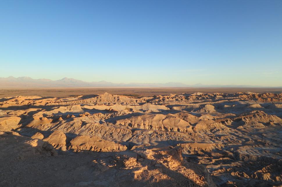 Free Image of Expansive desert landscape extending under a clear sky. 