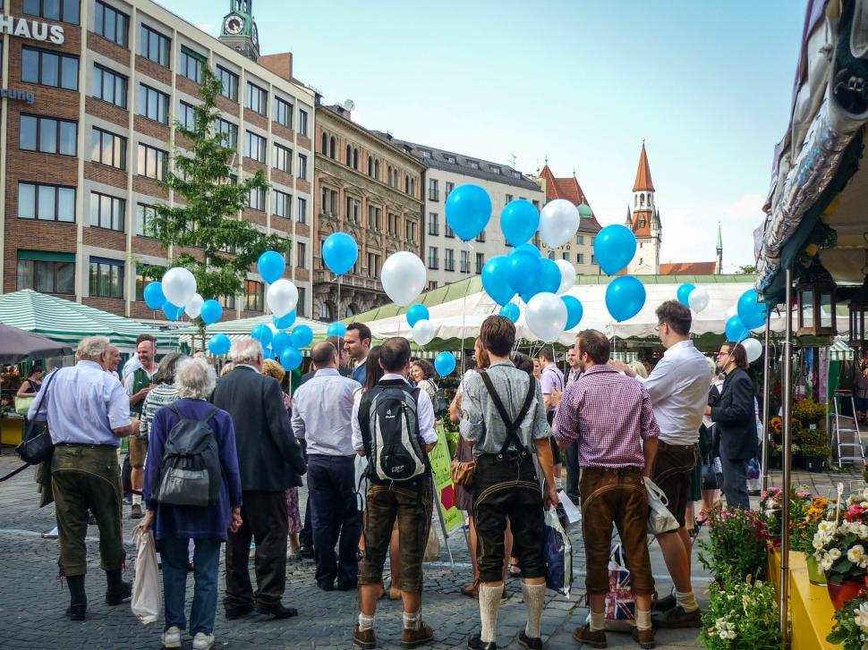 Free Image of Festival with balloons and people in traditional dress. 