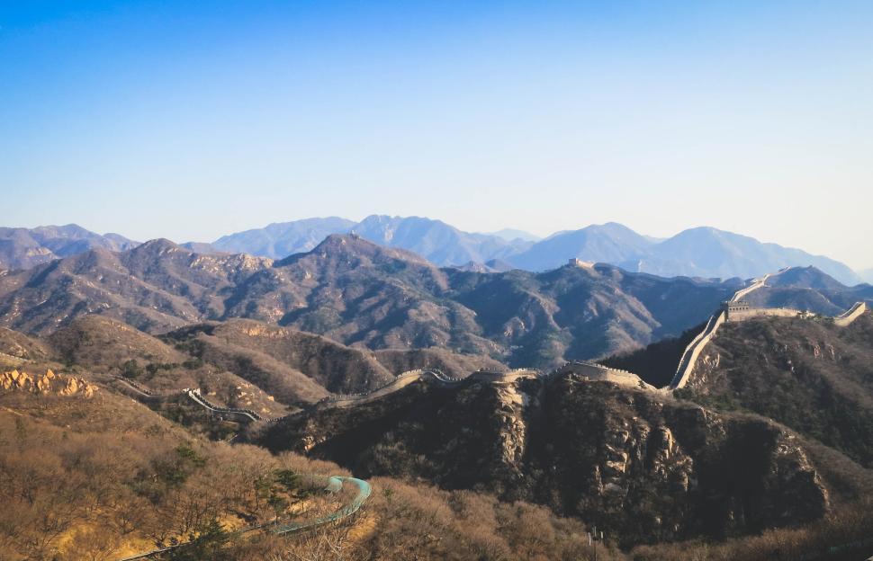 Free Image of The Great Wall winding across rugged mountain terrain 