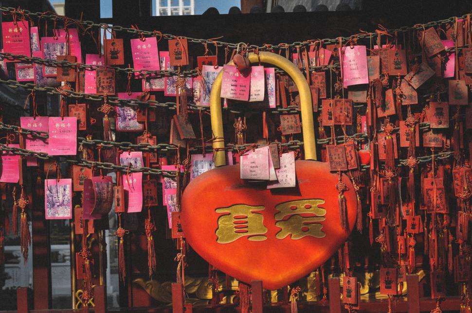 Free Image of Large red heart with love notes hanging all around 