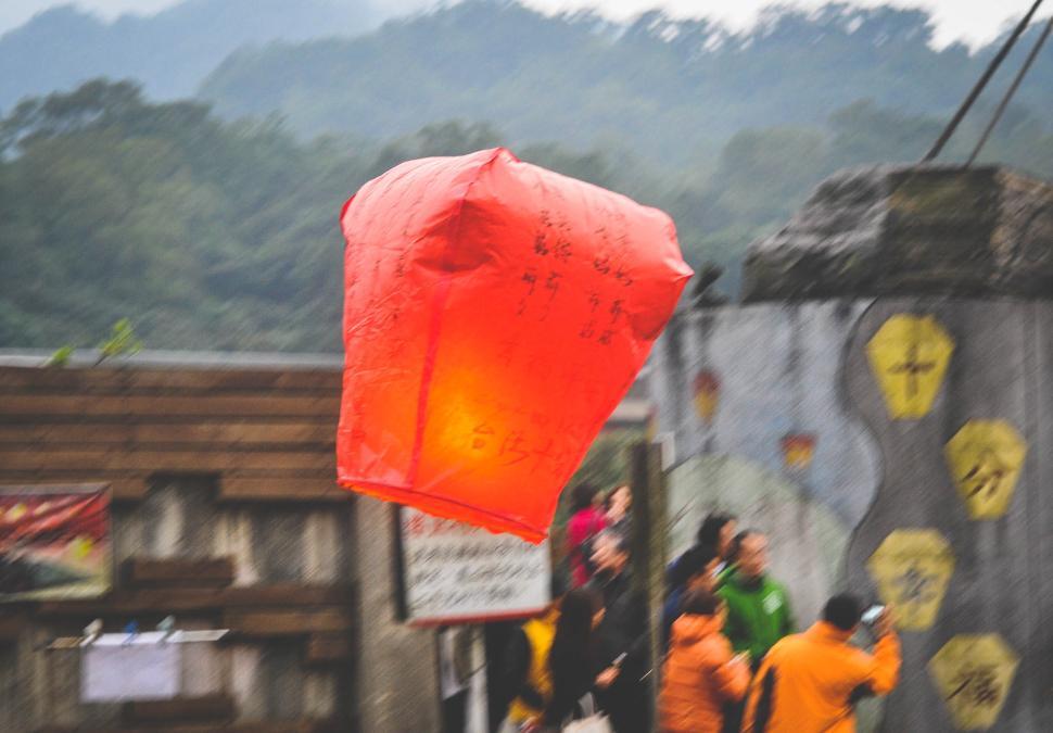 Free Image of Red lantern floating in air during traditional festival 