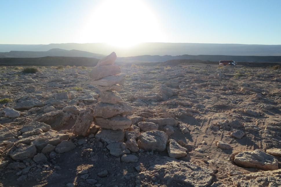Free Image of Pile of stones on a rocky landscape at sunrise 