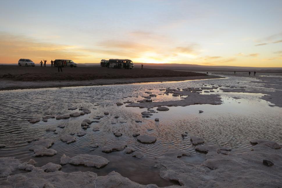 Free Image of Sunset over scenic water with scattered fragments visible. 