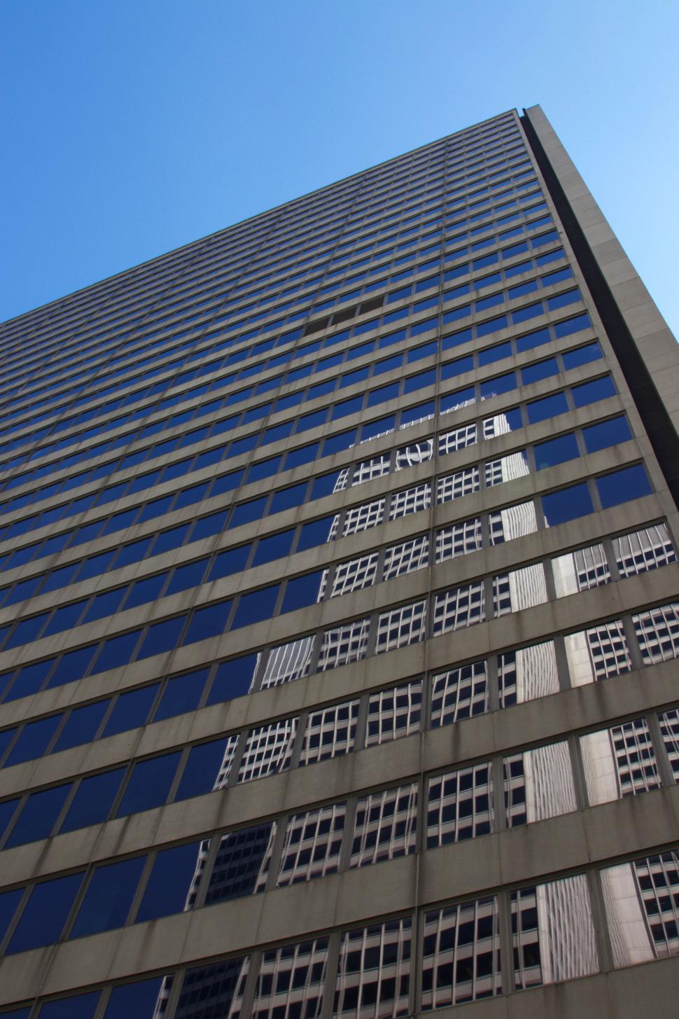 Free Image of Tall skyscrapers reflecting off each other in city 