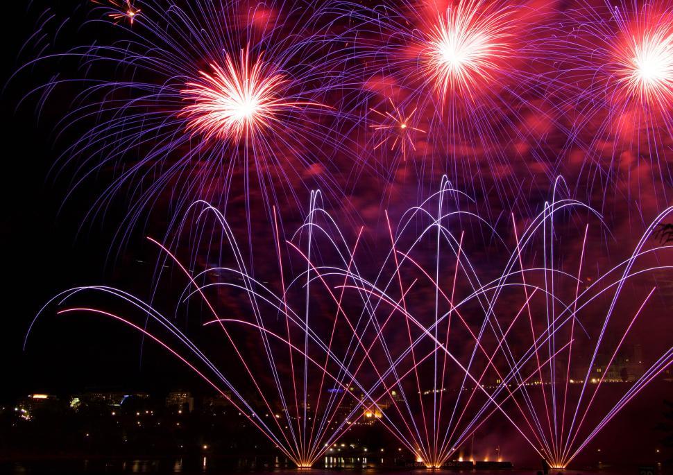 Free Image of Colorful fireworks bursting over city skyline at night 