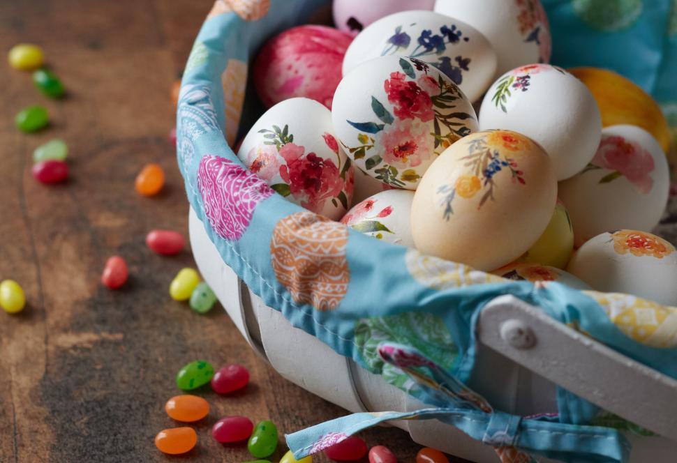 Free Image of Basket of hand-decorated Easter eggs with jelly beans 
