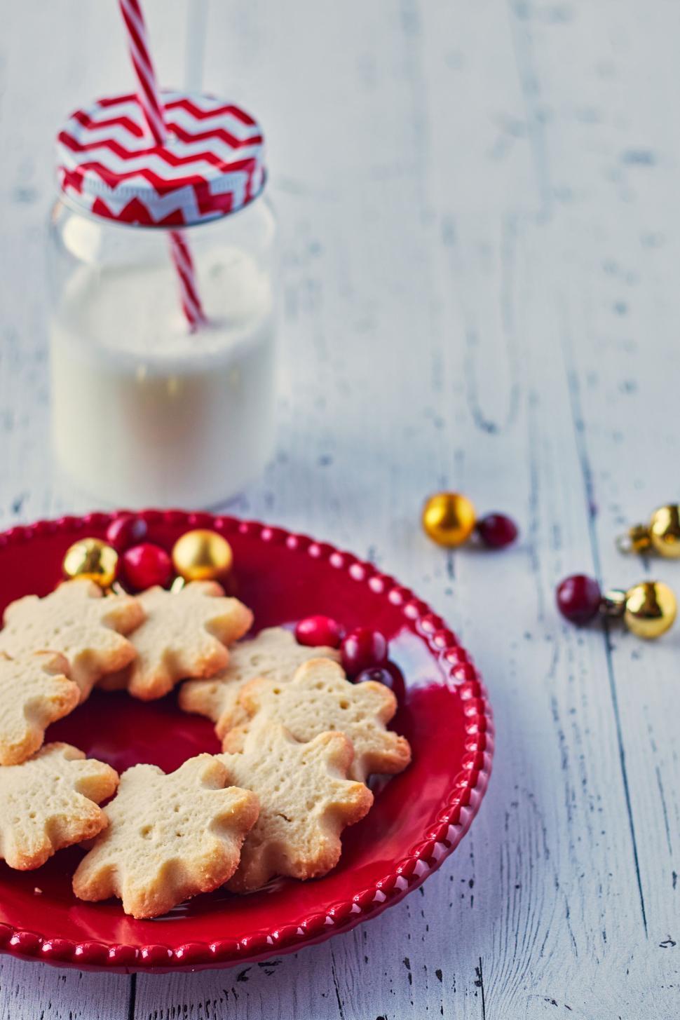 Free Image of Holiday sugar cookies with milk on white wooden table. 