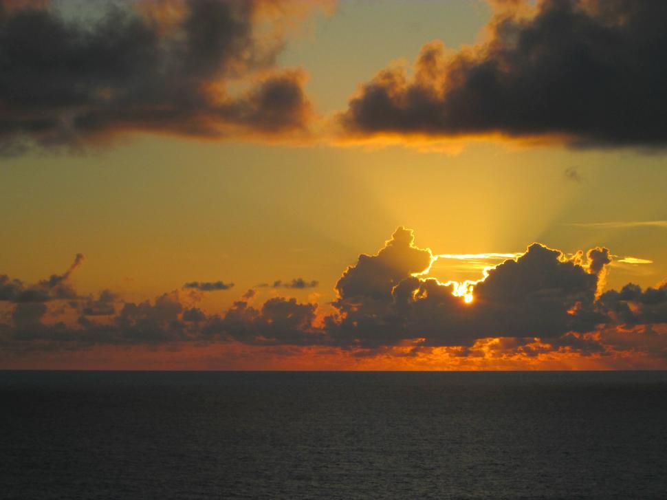 Free Image of Beautiful sunset over the ocean with dramatic clouds. 