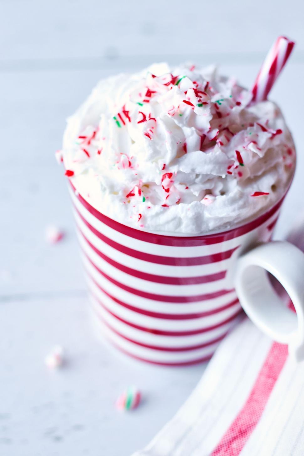 Free Image of Festive peppermint beverage with whipped cream and candy. 