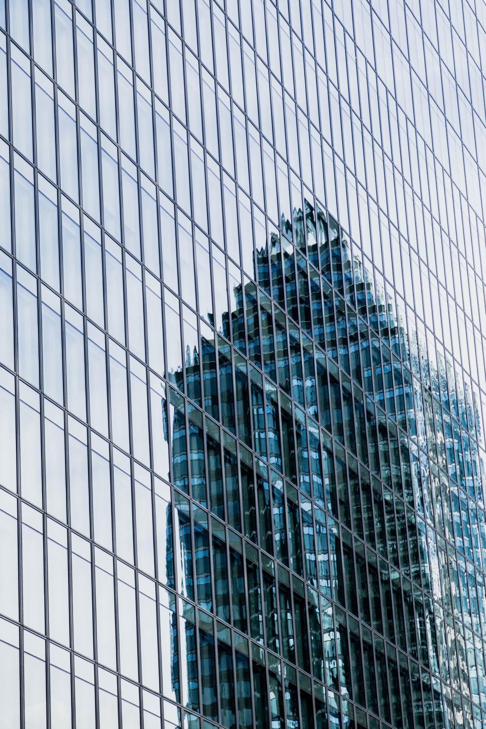 Free Image of Reflection of a skyscraper on another glass building. 