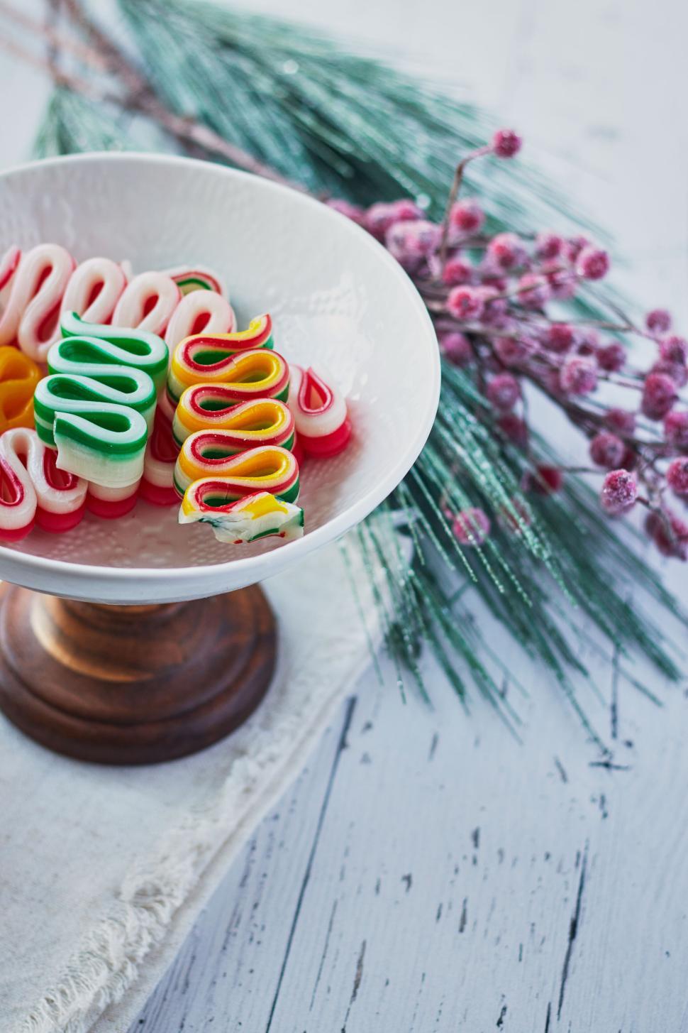 Free Image of Colorful festive candy ribbon on white dish display 