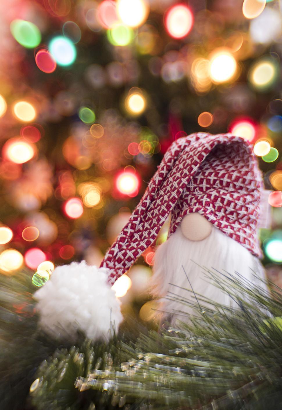 Free Image of Festive gnome with a red hat in a bokeh background. 