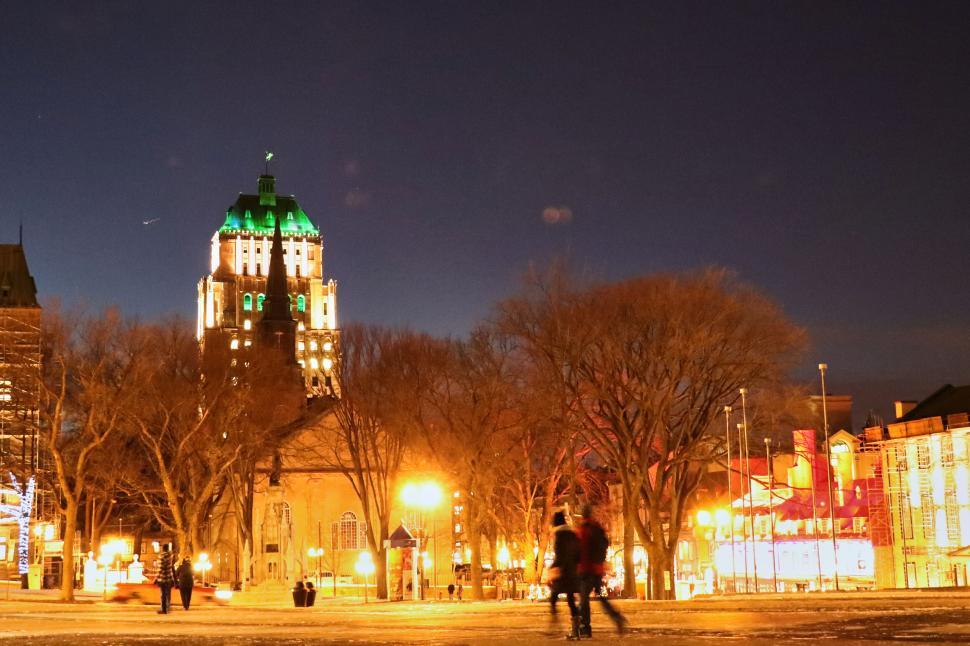 Free Image of Illuminated historic building in a city square at dusk 