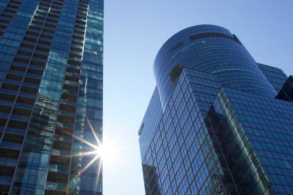 Free Image of Modern glass skyscrapers reflecting sunlight into lens 