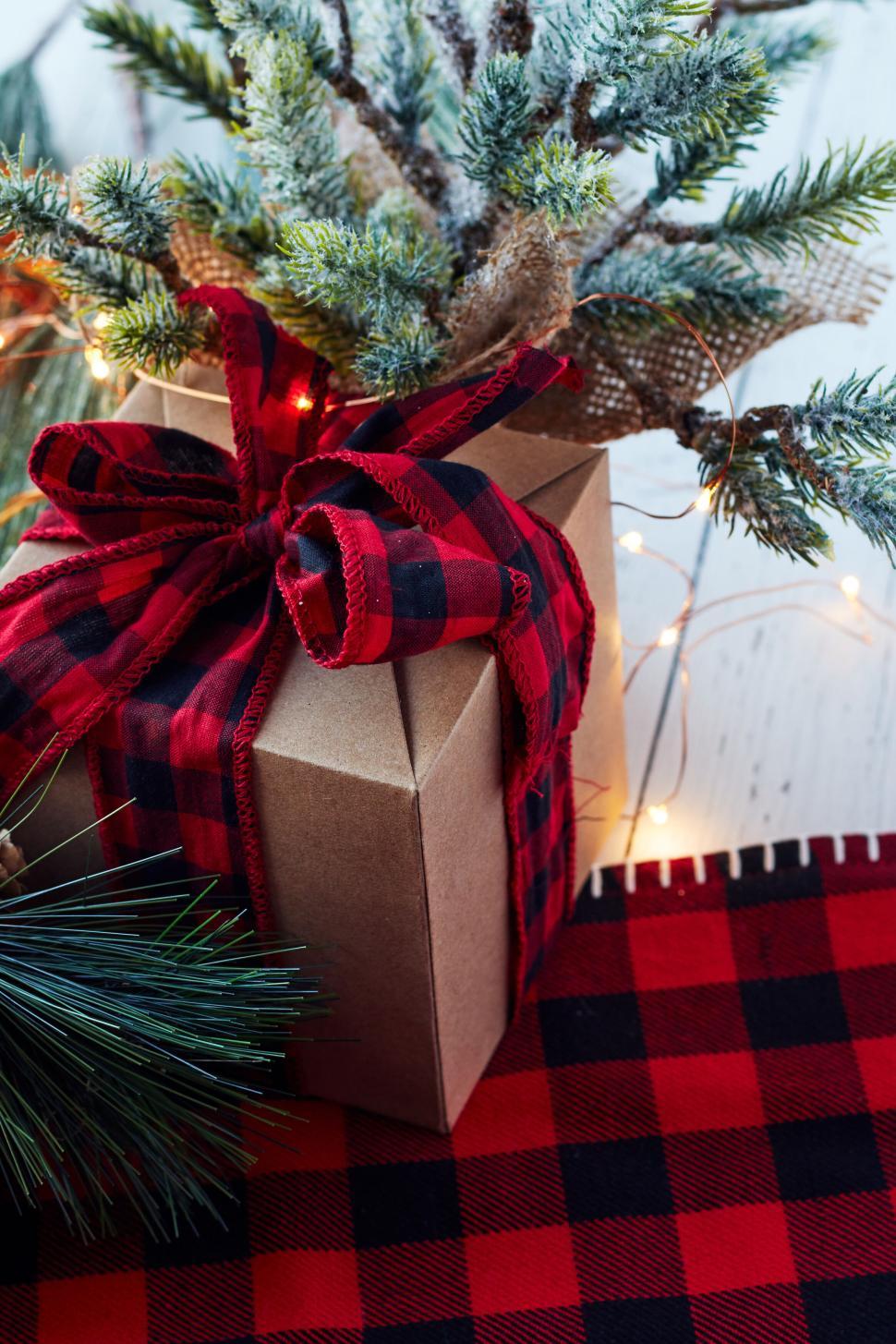 Free Image of Gift box with festive decorations and pine branches 