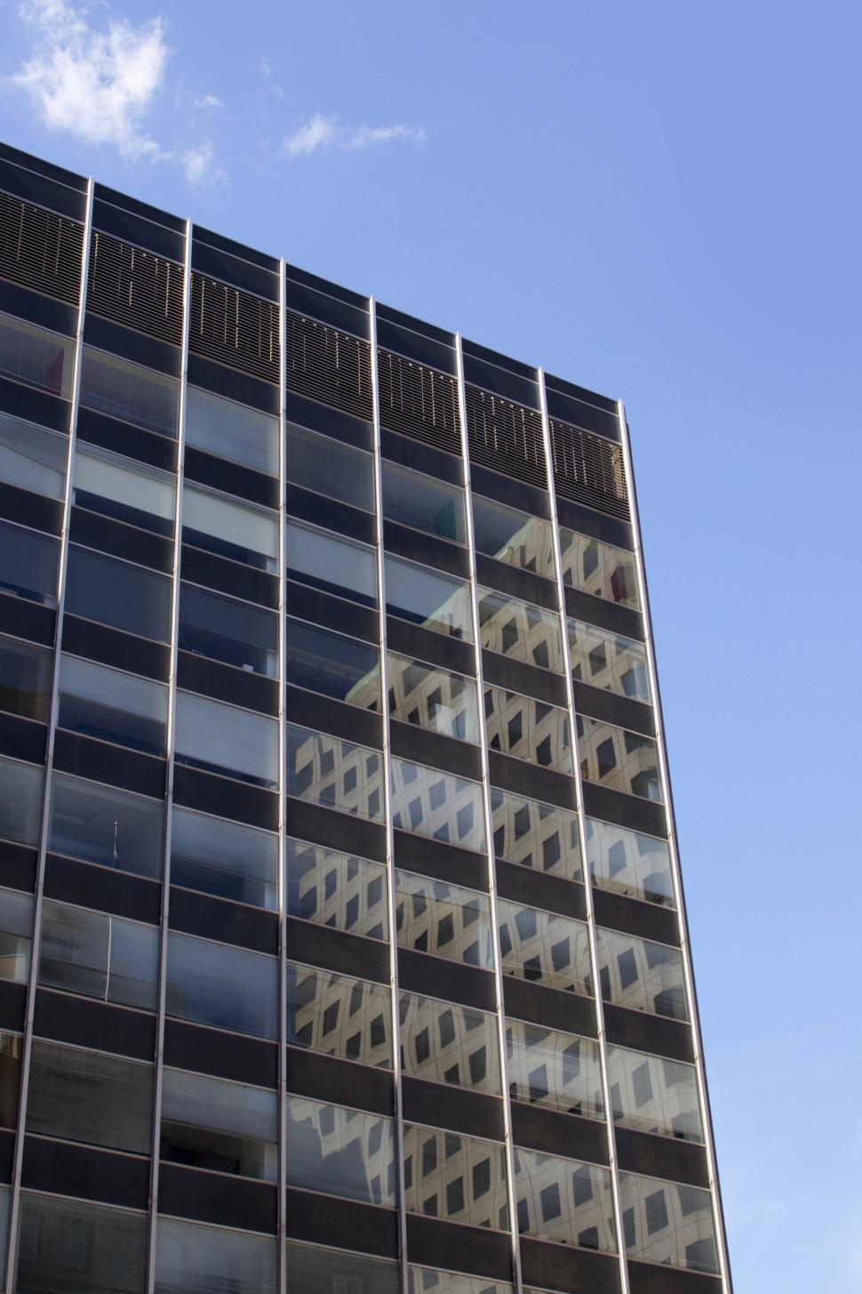 Free Image of Modern high-rise building with glass windows and reflections 