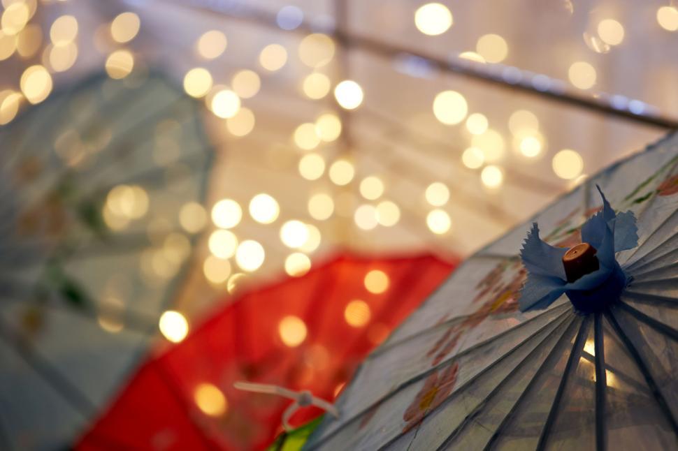 Free Image of Colorful paper umbrellas with bokeh light decoration. 