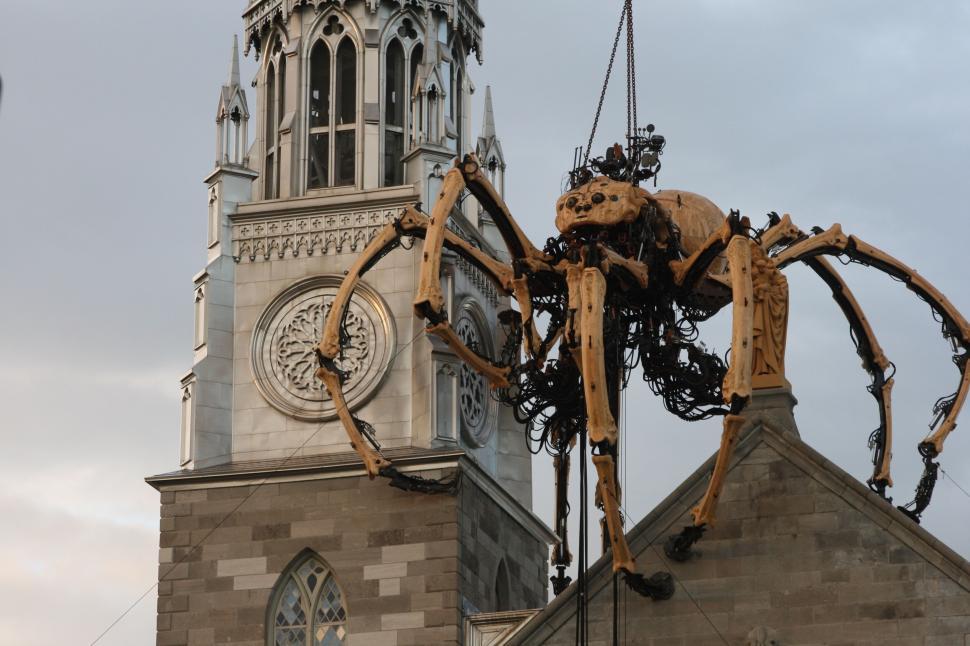 Free Image of Large mechanical spider installation on historic building 