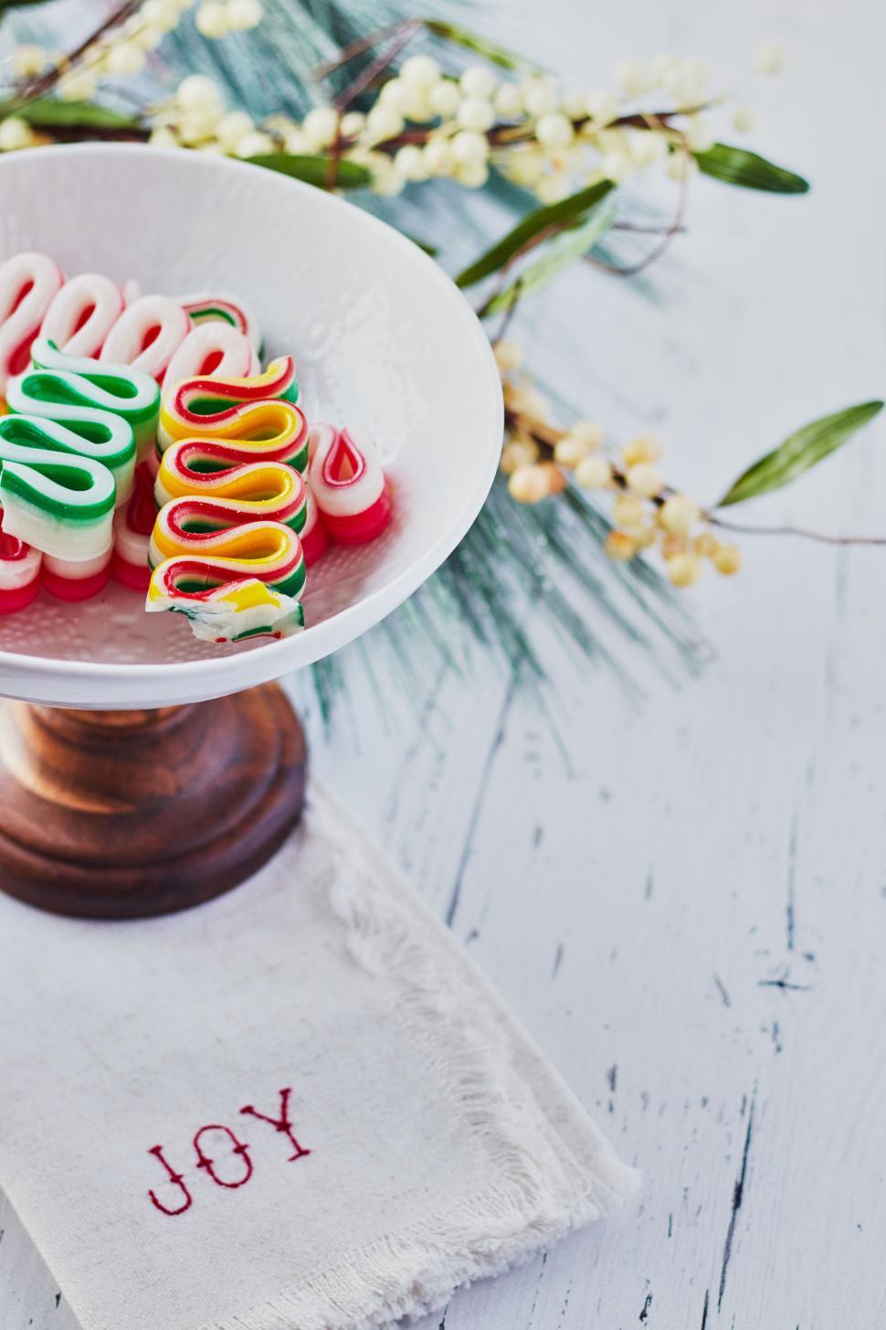 Free Image of Colorful candy ribbons in a white bowl on a stand. 