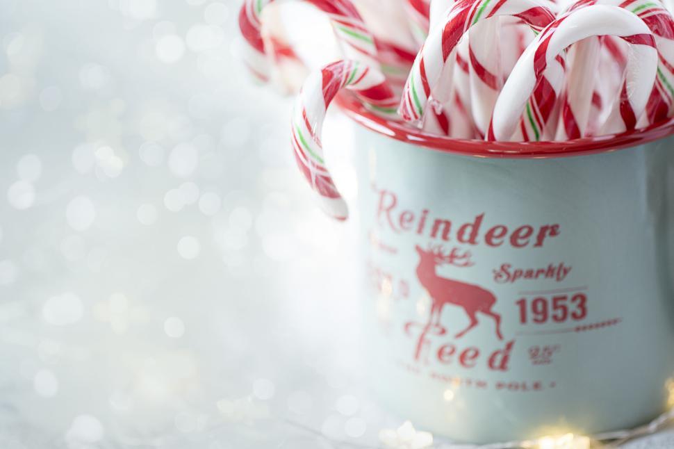 Free Image of Festive mug filled with peppermint candy canes stripes 