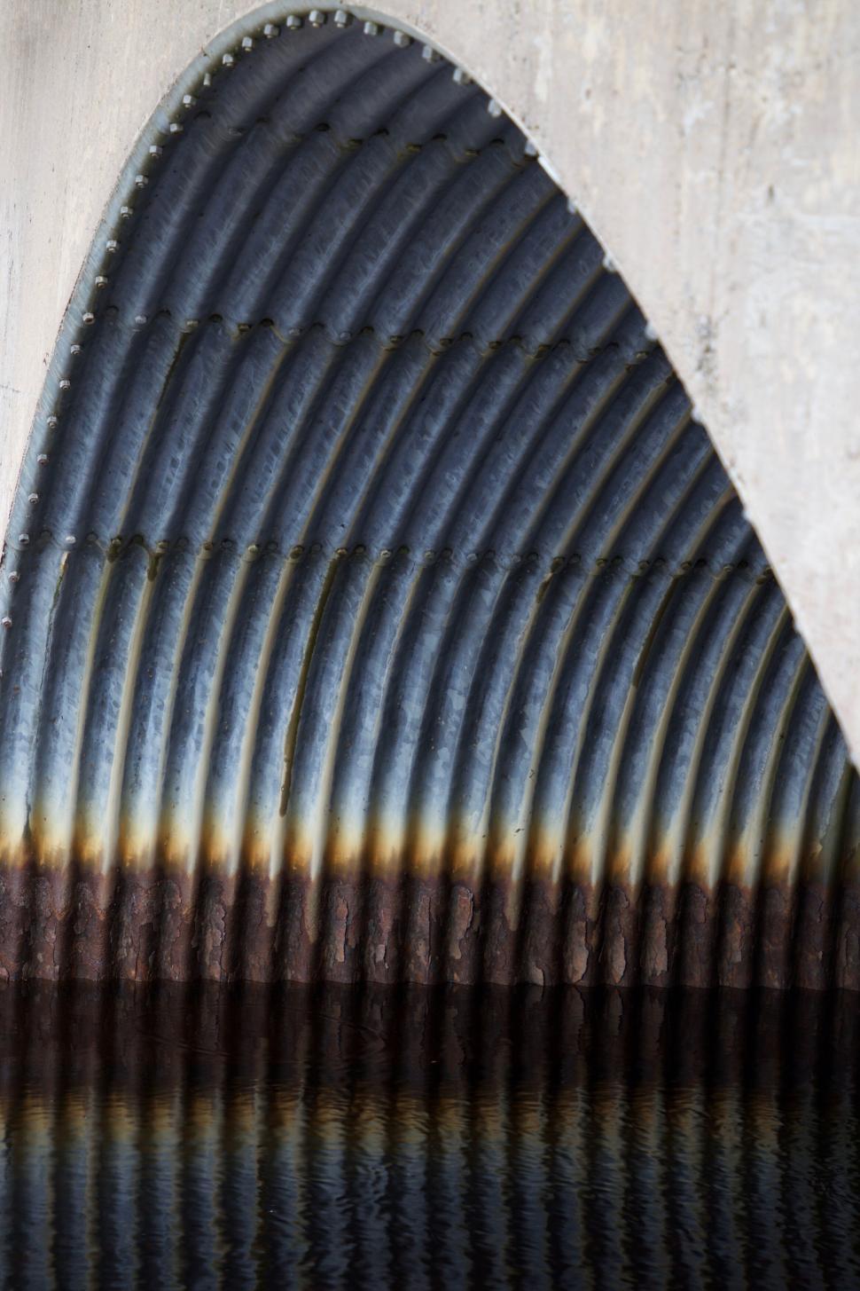 Free Image of Abstract corrugated structure with a curved archway 