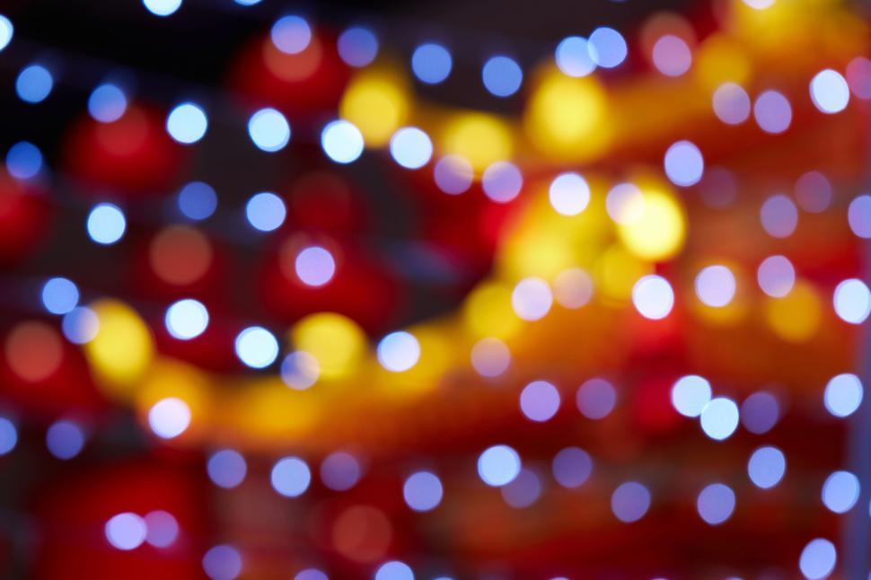Free Image of Blurred lights, creating a festive, colorful bokeh effect. 