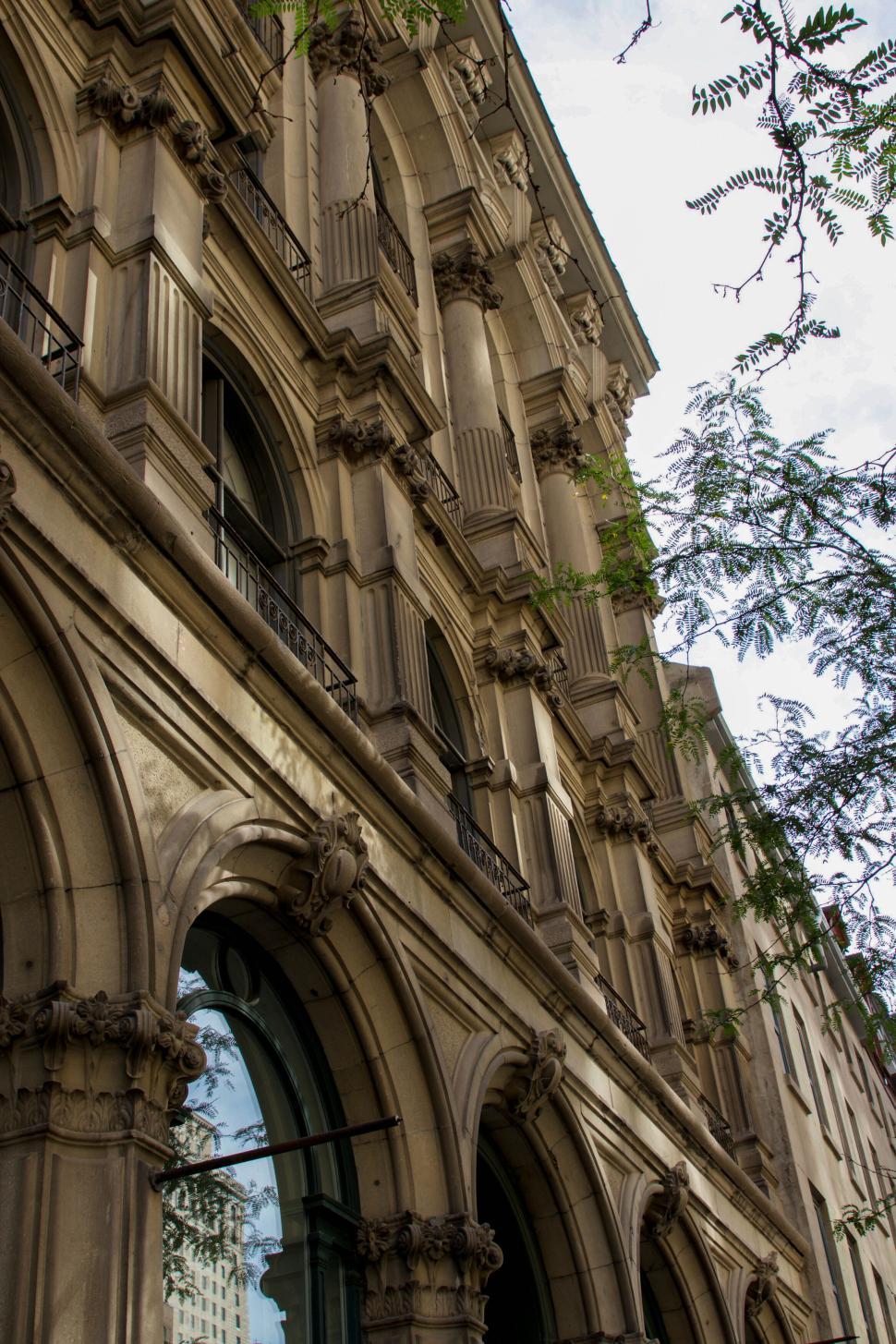 Free Image of Ornate architectural facade of an old multi-story building 