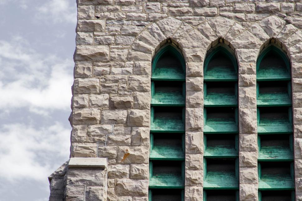 Free Image of Gothic architectural green windows in stone walls. 