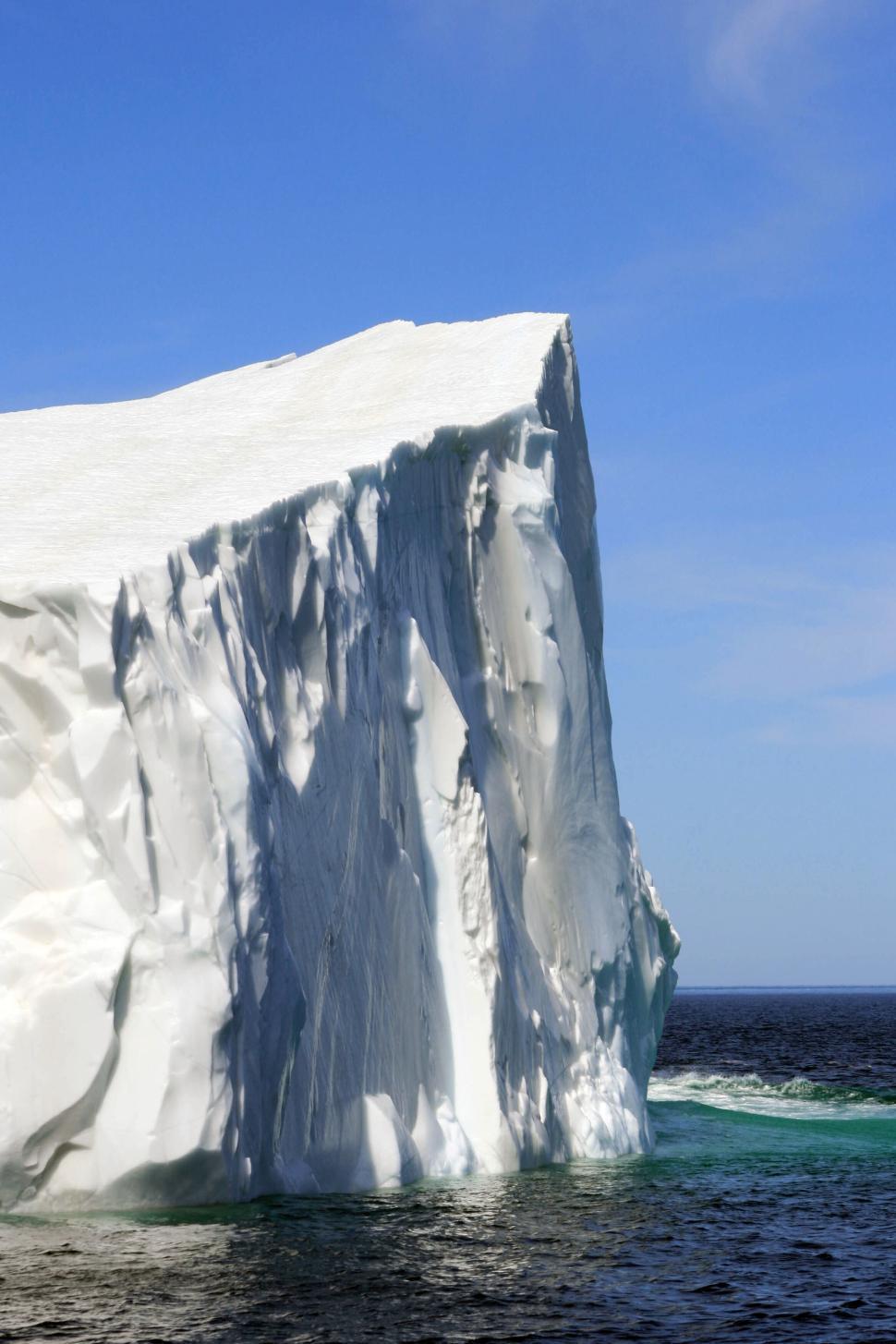 Free Image of Massive iceberg standing tall in pristine Arctic waters. 